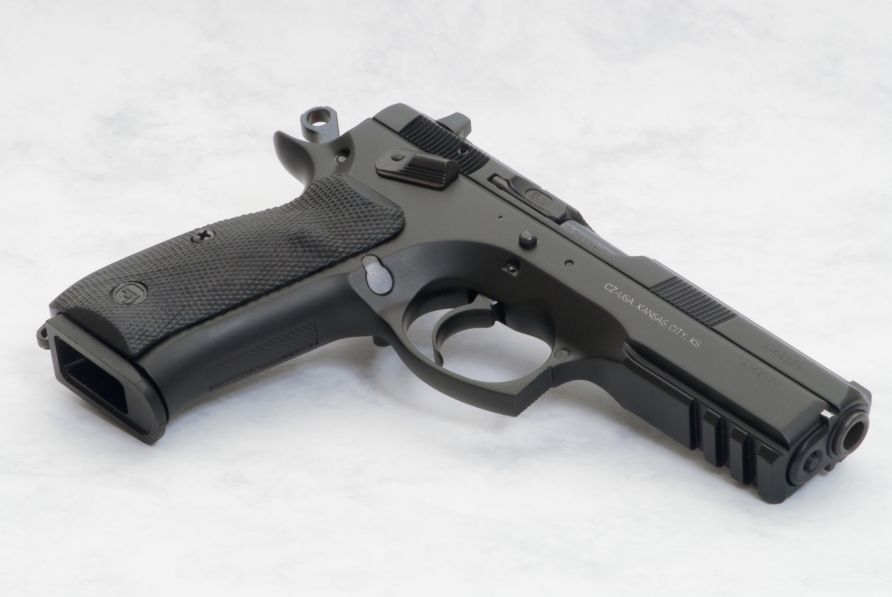 black handgun on white surface