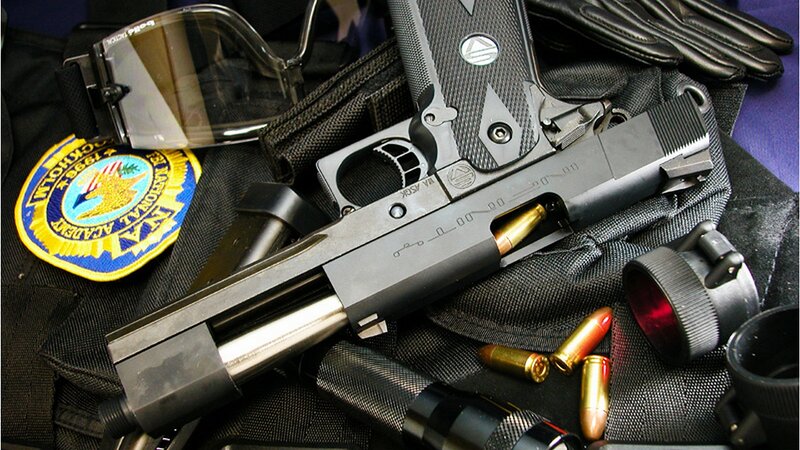 Black Handgun with Accessories — Tense