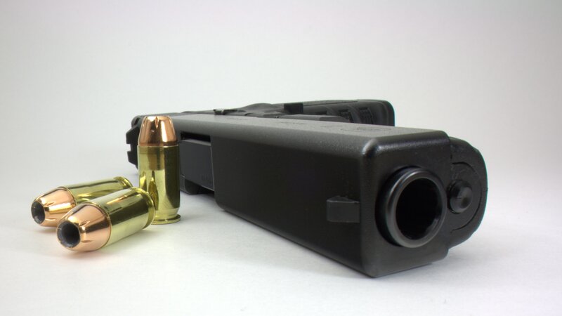 black handgun with bullets