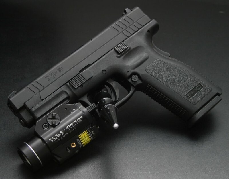 Black handgun with flashlight