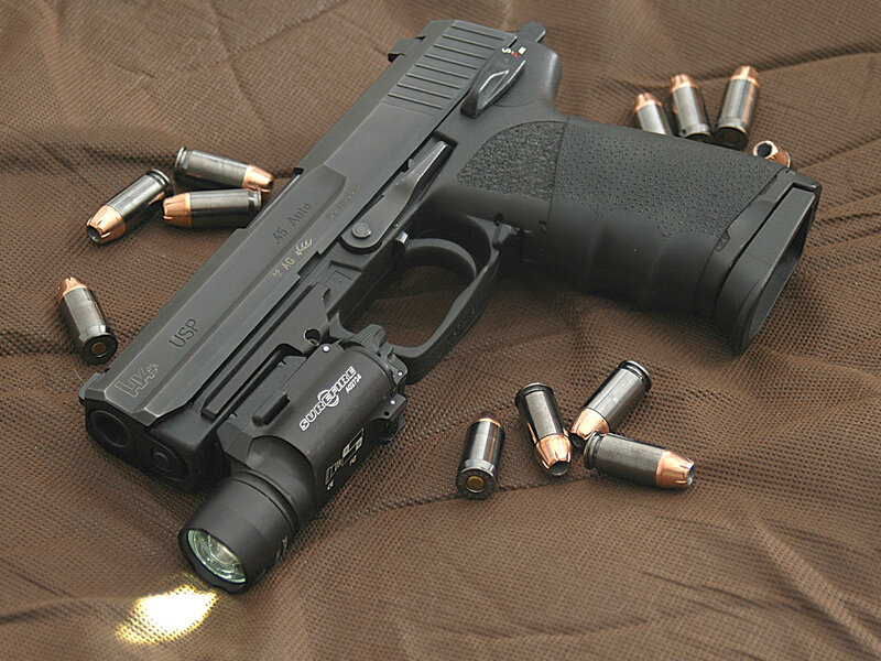 Black handgun with flashlight