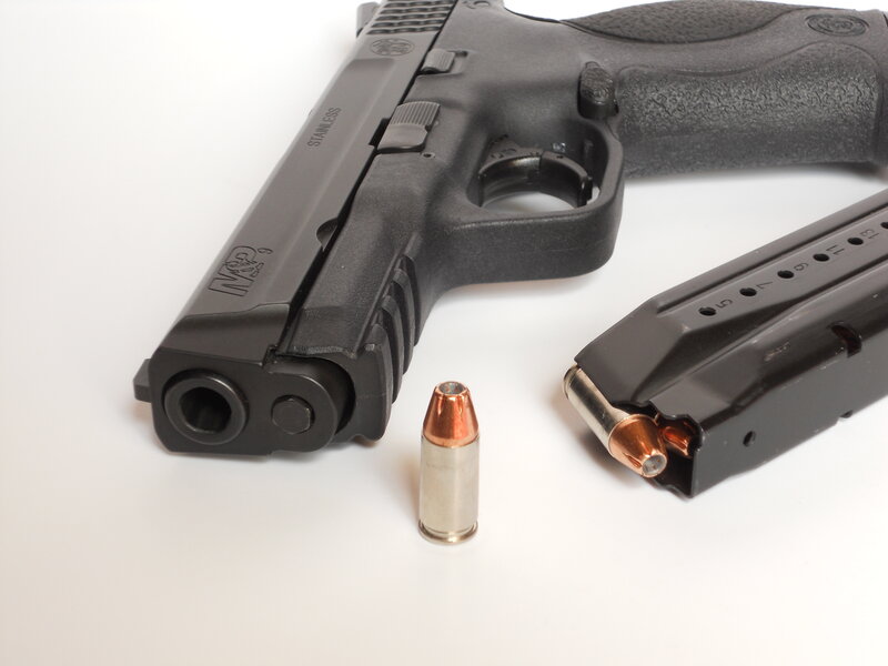 Black handgun with magazine and bullet