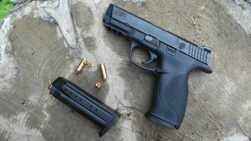 Black handgun with magazine and bullets