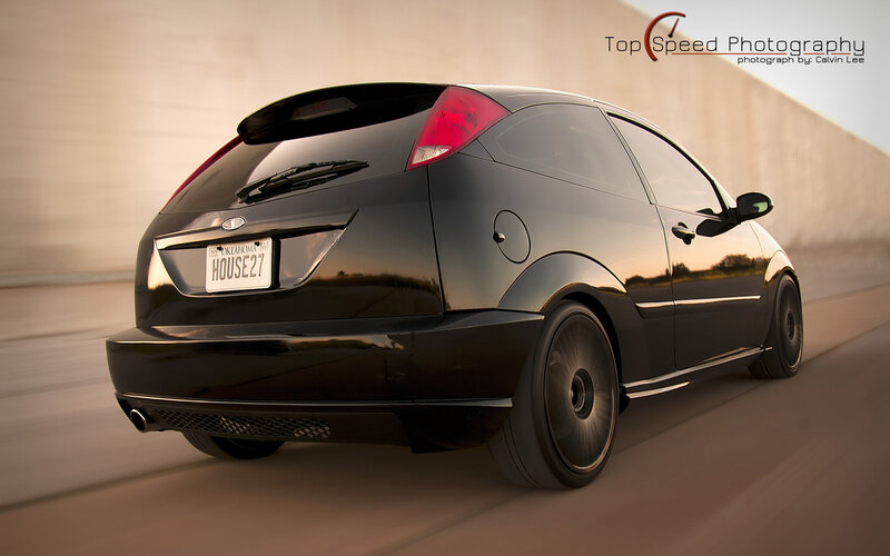black hatchback in motion