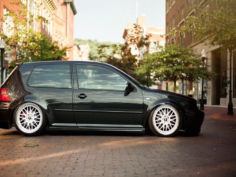 black hatchback on city street