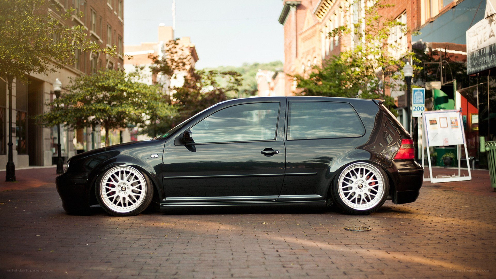 black hatchback on city street