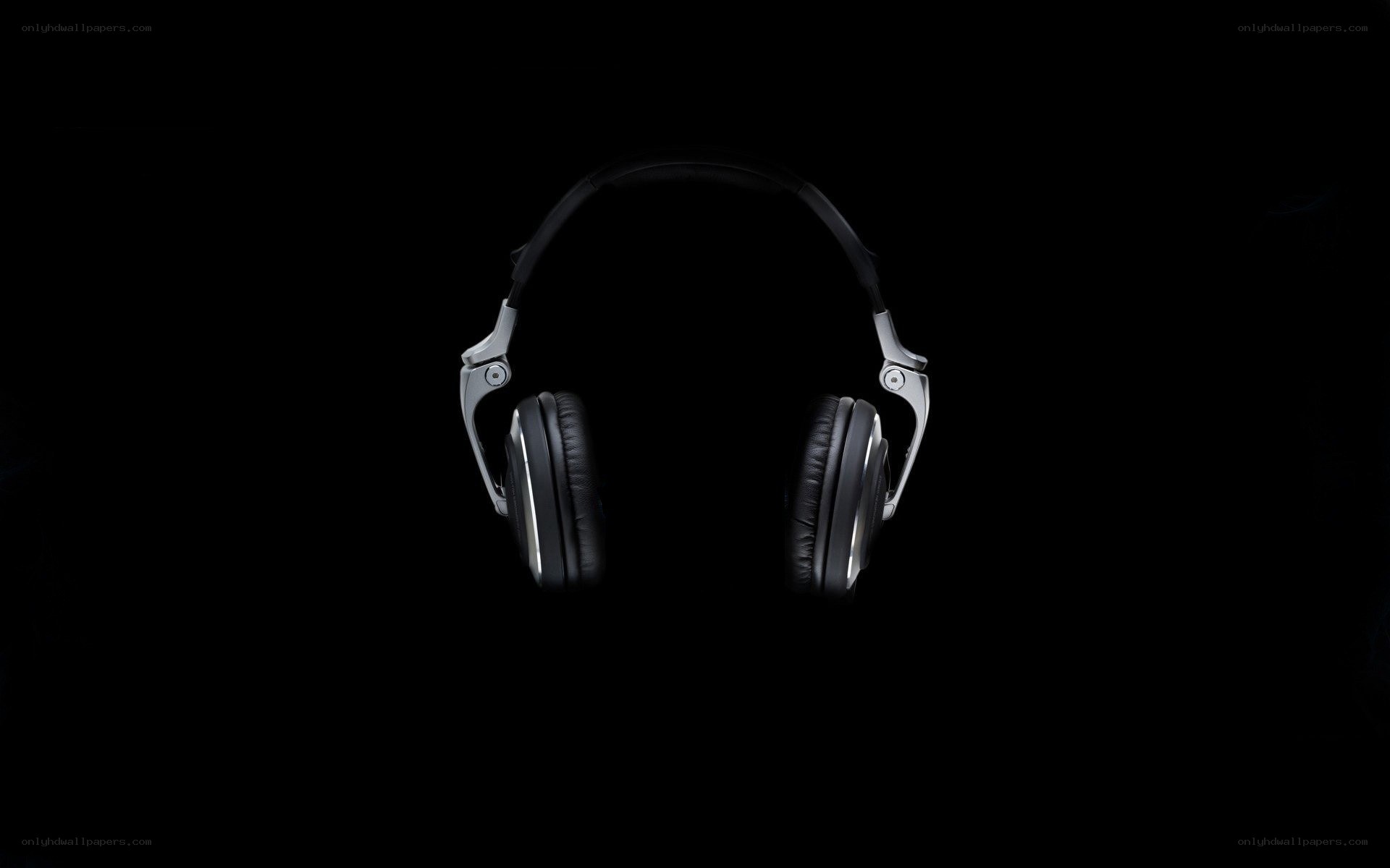 black headphones on black background