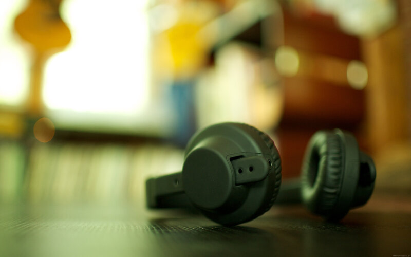 black headphones on wooden surface