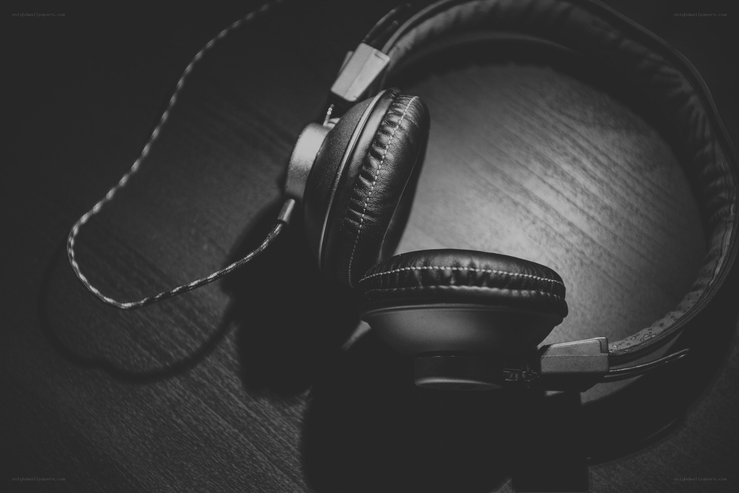 black headphones on wooden surface