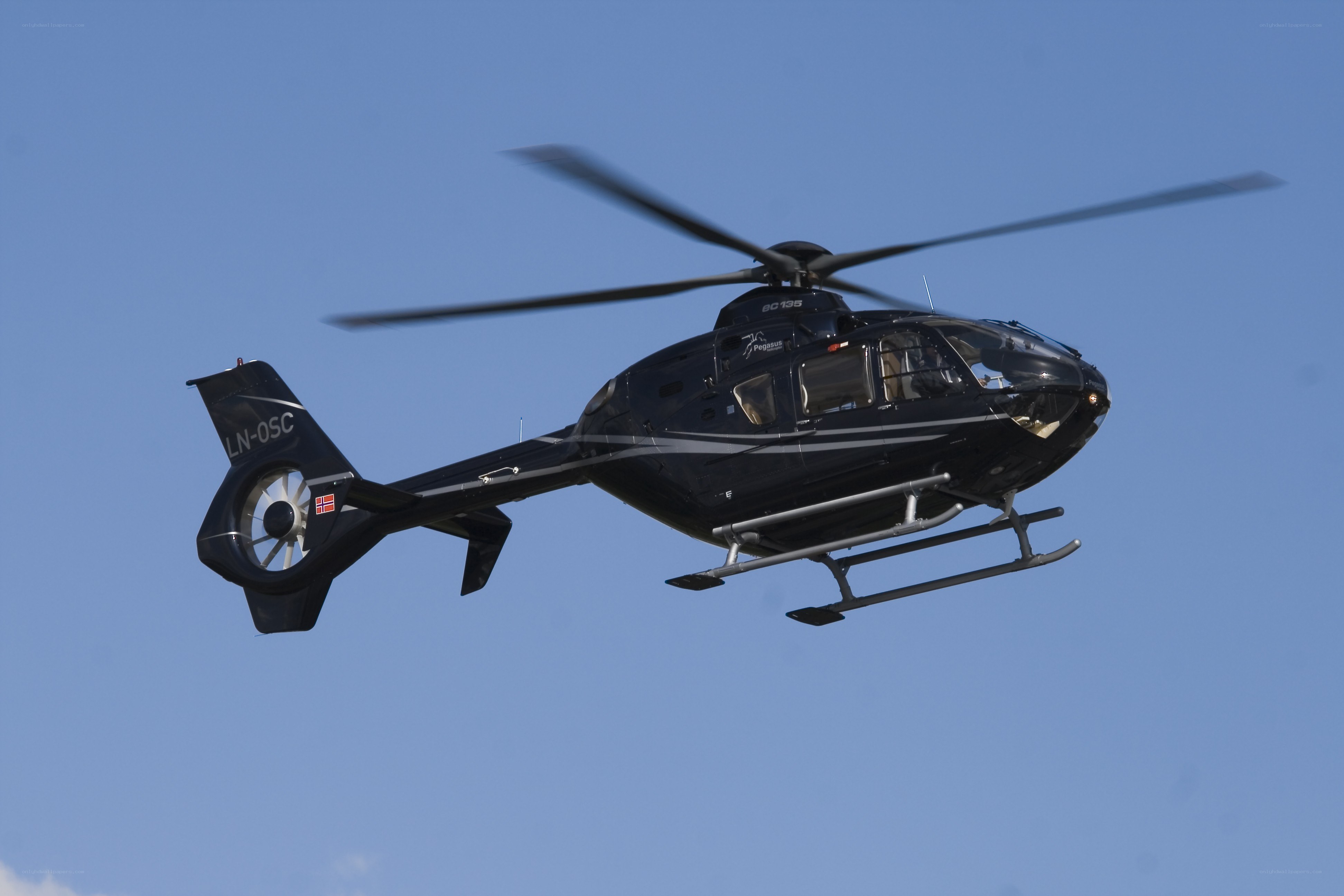Black helicopter in flight