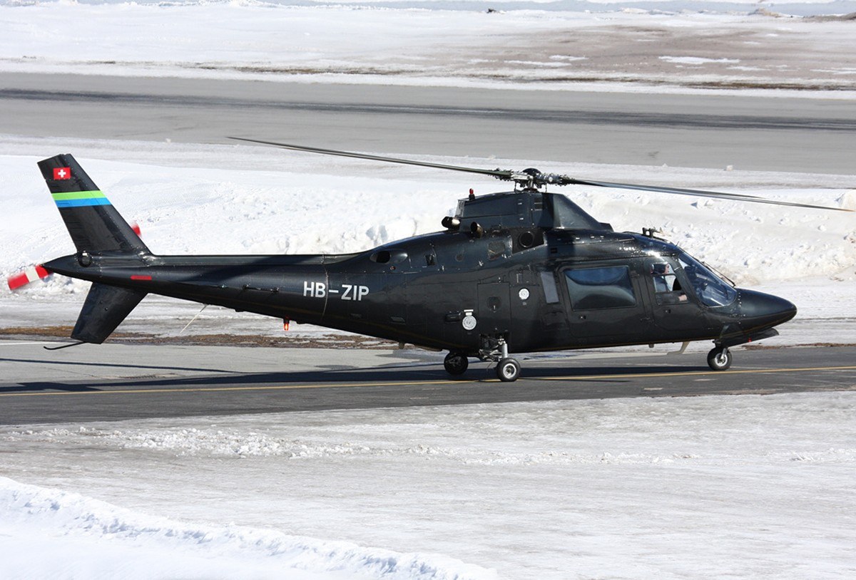 Black helicopter on snowy runway