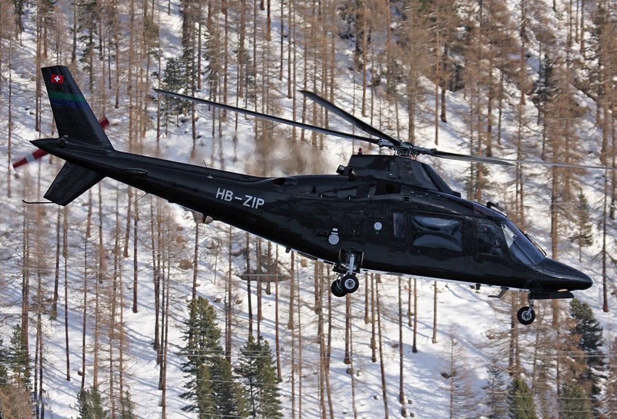 Black helicopter over snowy forest