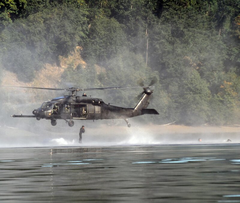 Black Helicopter over Water — Dramatic