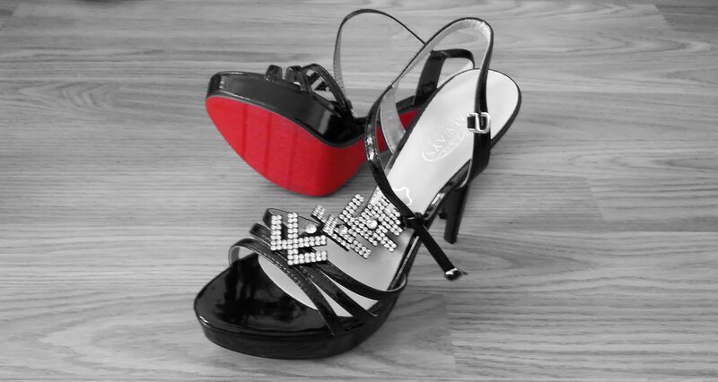 Black high-heeled sandals with red soles