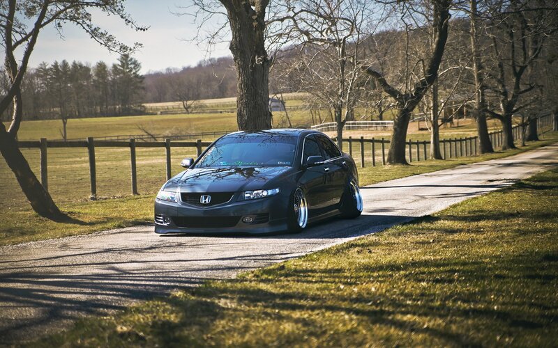 Black Honda Acura on a country road