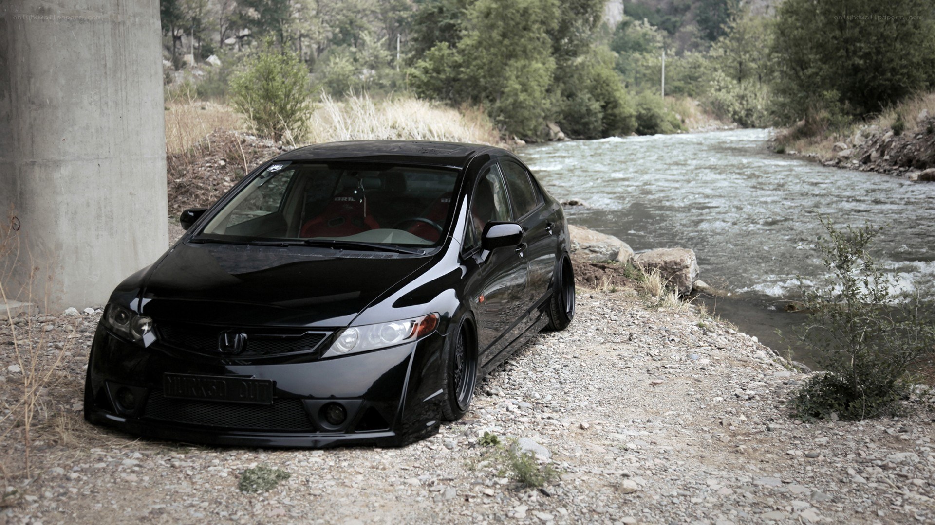 black honda civic by a river