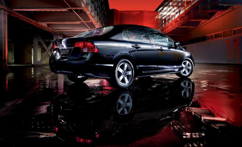 Black Honda Civic in wet garage