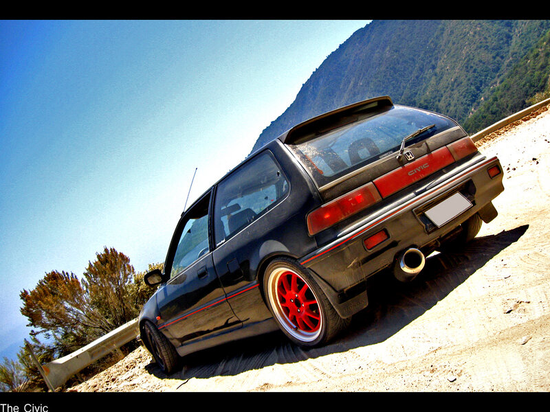 Black Honda Civic on a mountain road