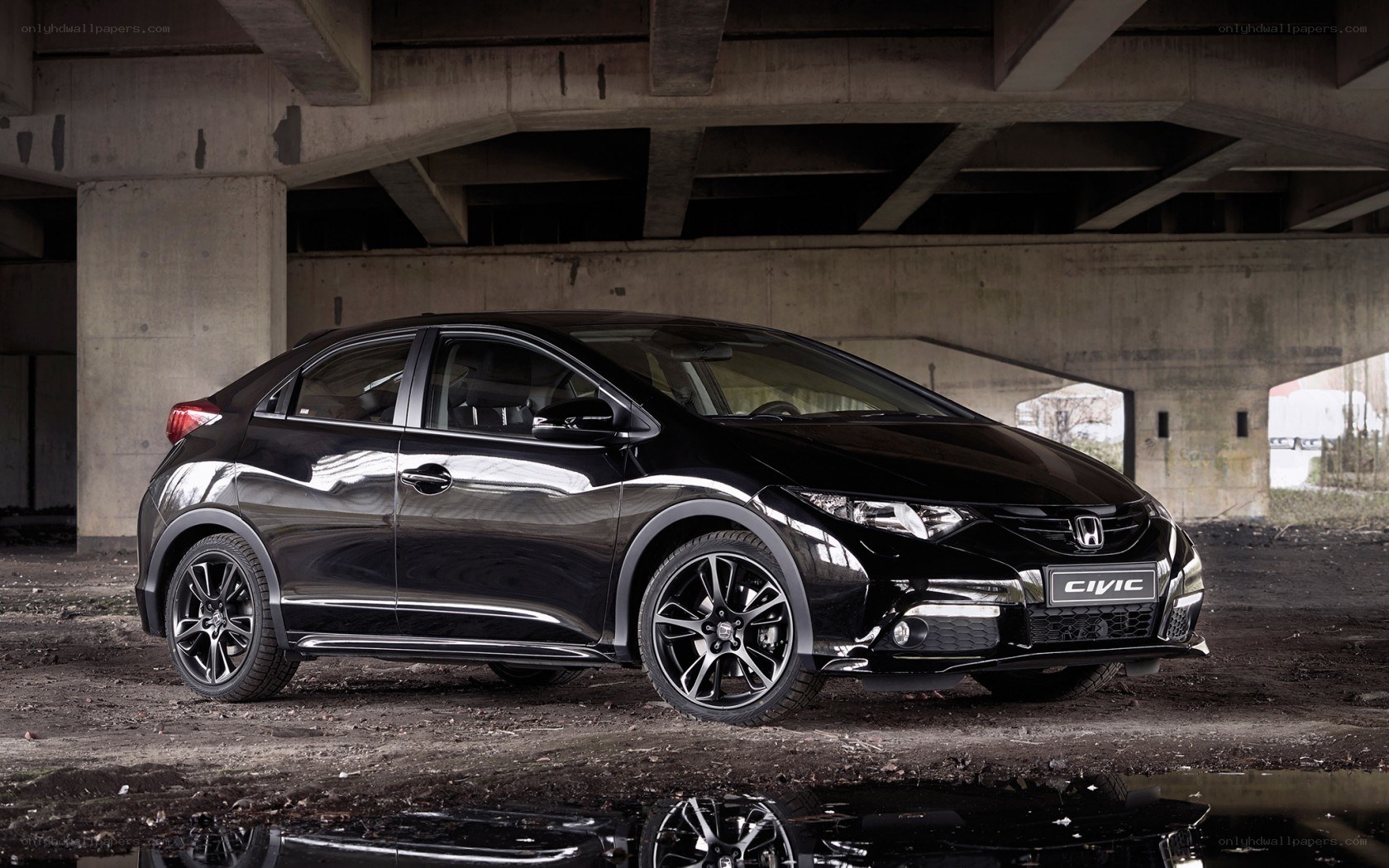 Black Honda Civic under bridge