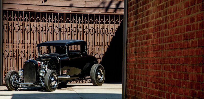 Black Hot Rod Car — Dramatic, Afternoon, Photograph, Brick Wall, Metal Gate