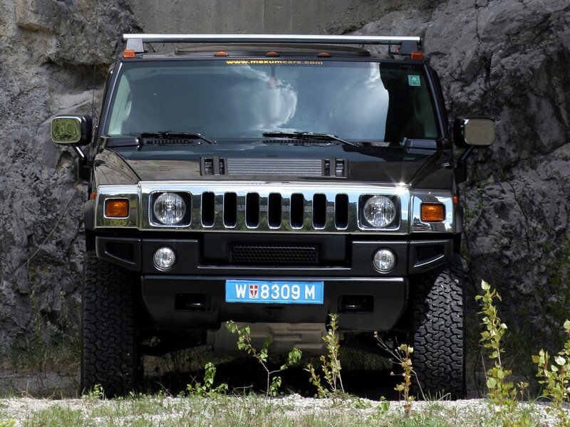 Black Hummer H2 parked in rock
