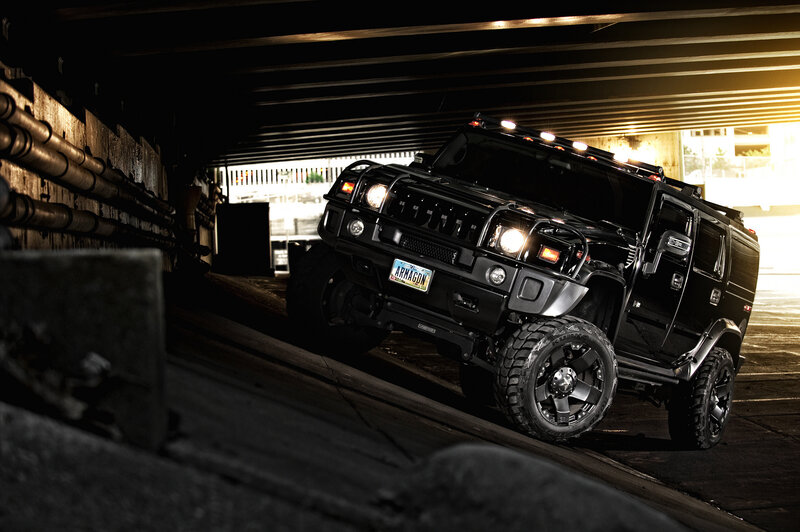 Black Hummer under bridge