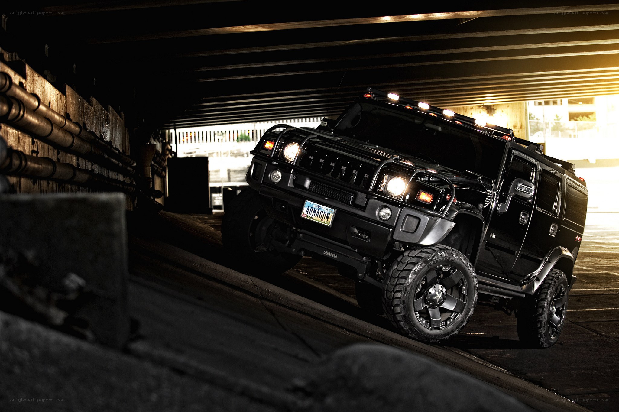 Black Hummer under bridge