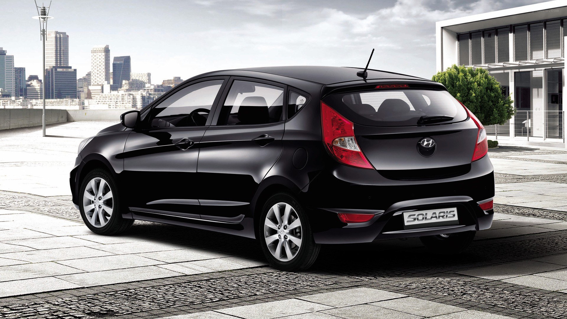 Black Hyundai Solaris hatchback