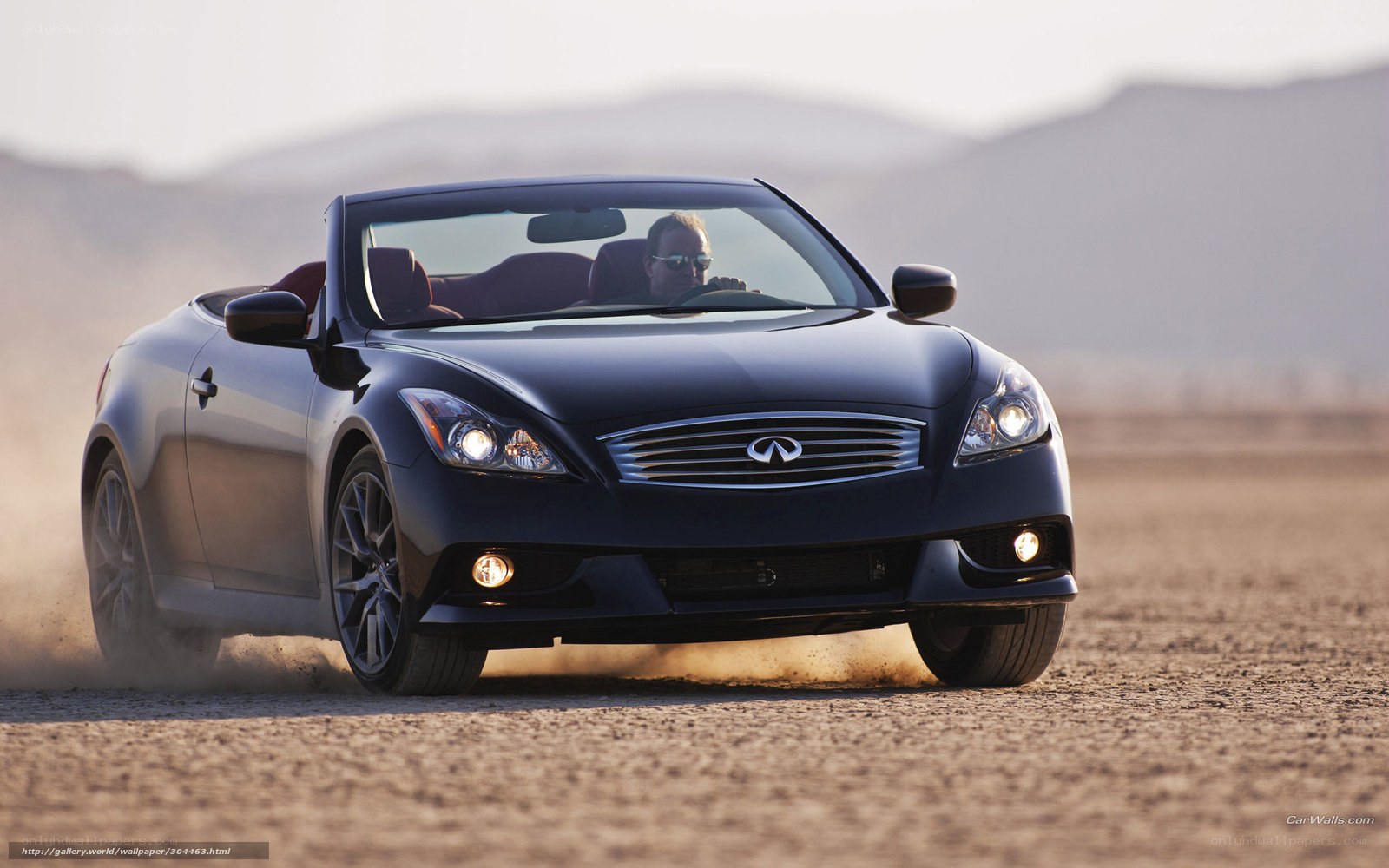 black infiniti convertible on dirt road