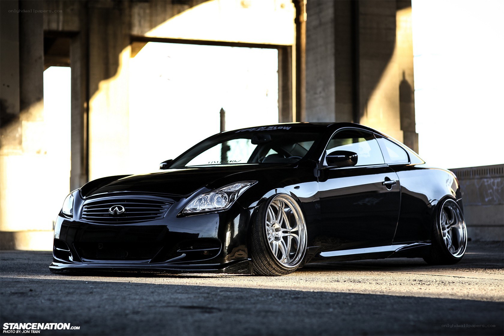 black infiniti coupe under bridge