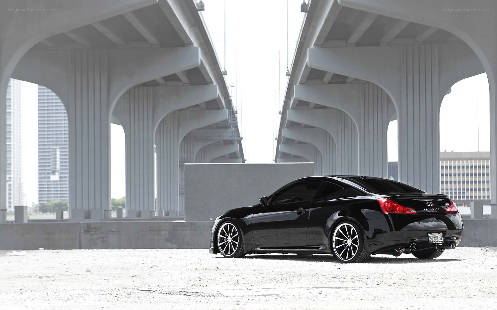 Black Infiniti coupe under bridge