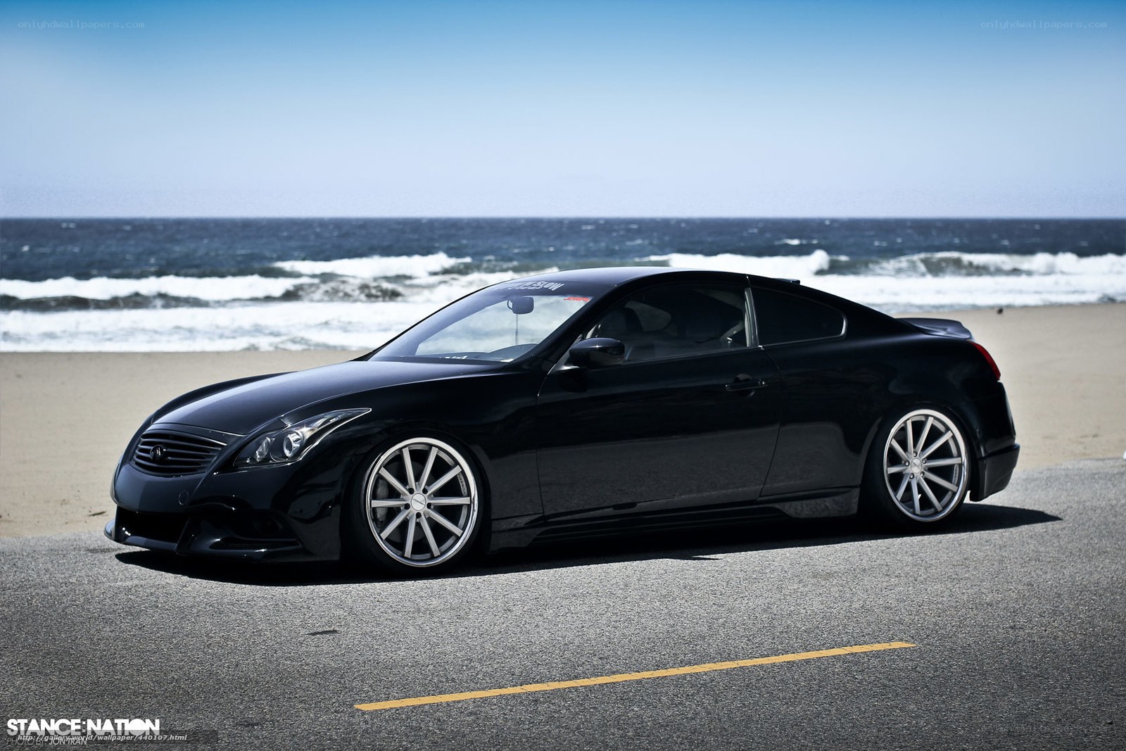 Black Infiniti G37 on beach