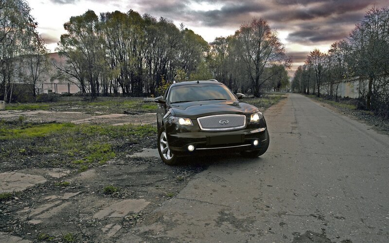 black infiniti on a rural road