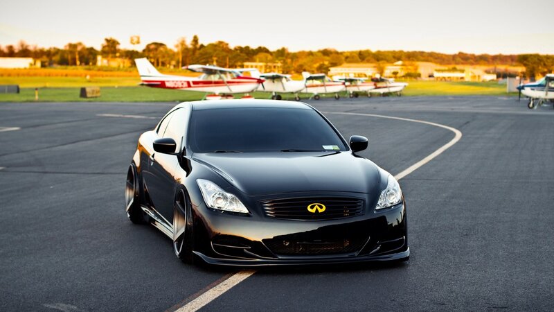Black Infiniti on an airfield