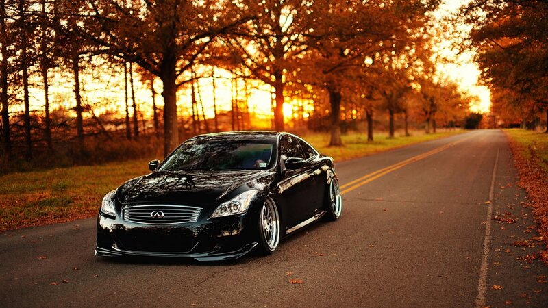 Black Infiniti on autumn road