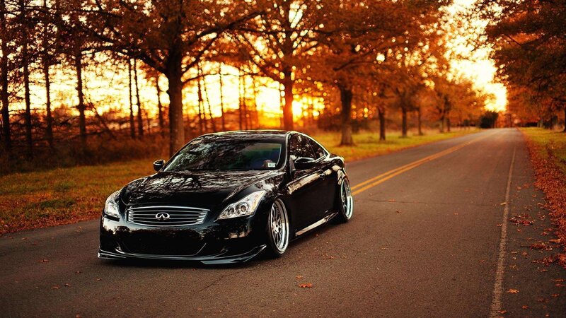 Black Infiniti on autumn road