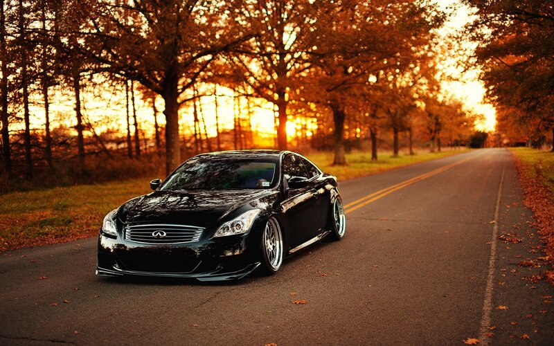 Black Infiniti on autumn road