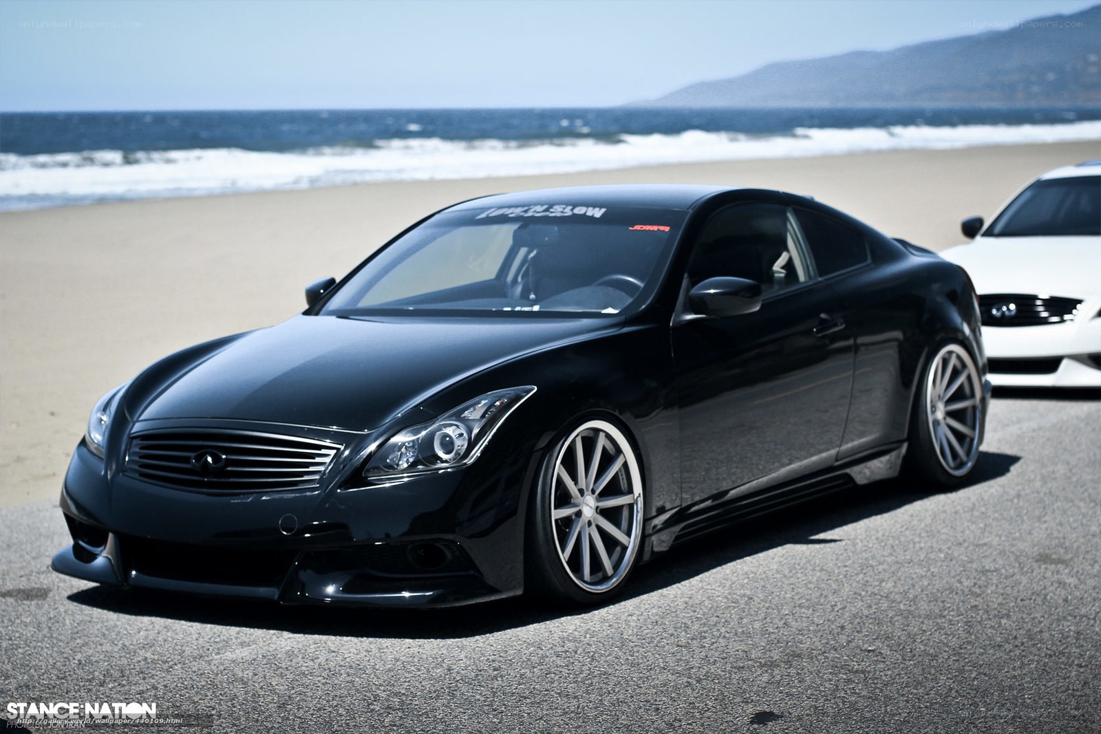 Black Infiniti on the beach