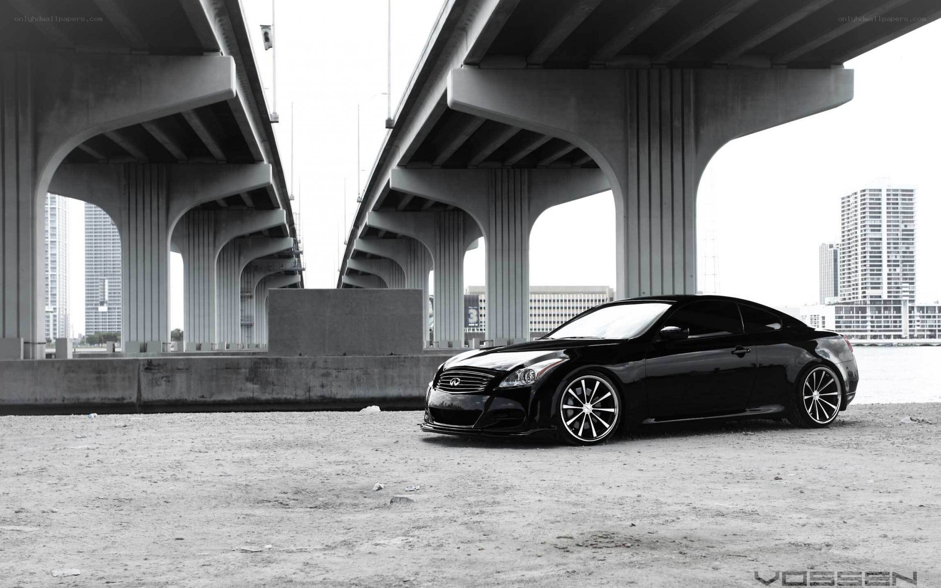 Black Infiniti under a bridge