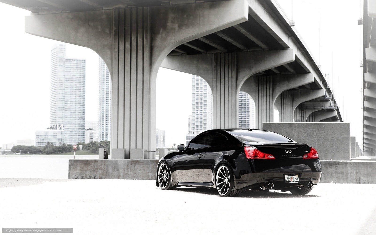 Black Infiniti under a bridge
