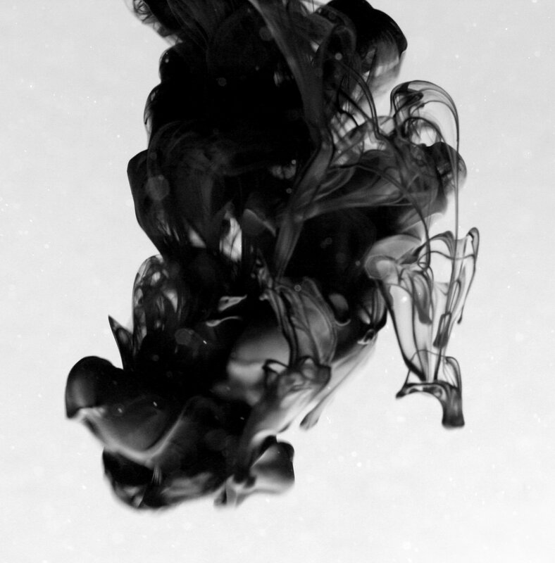 black ink dispersing in water