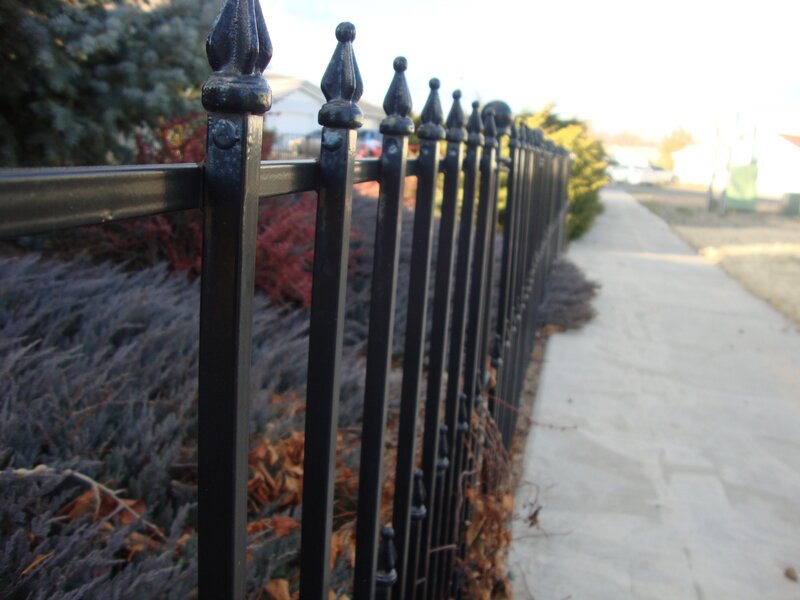 black iron fence along sidewalk
