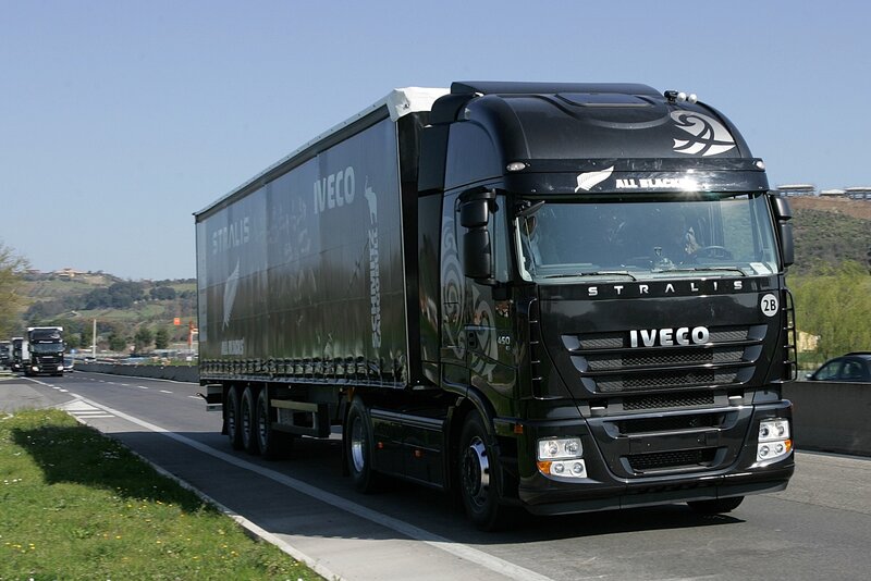 Black Iveco Stralis truck on highway