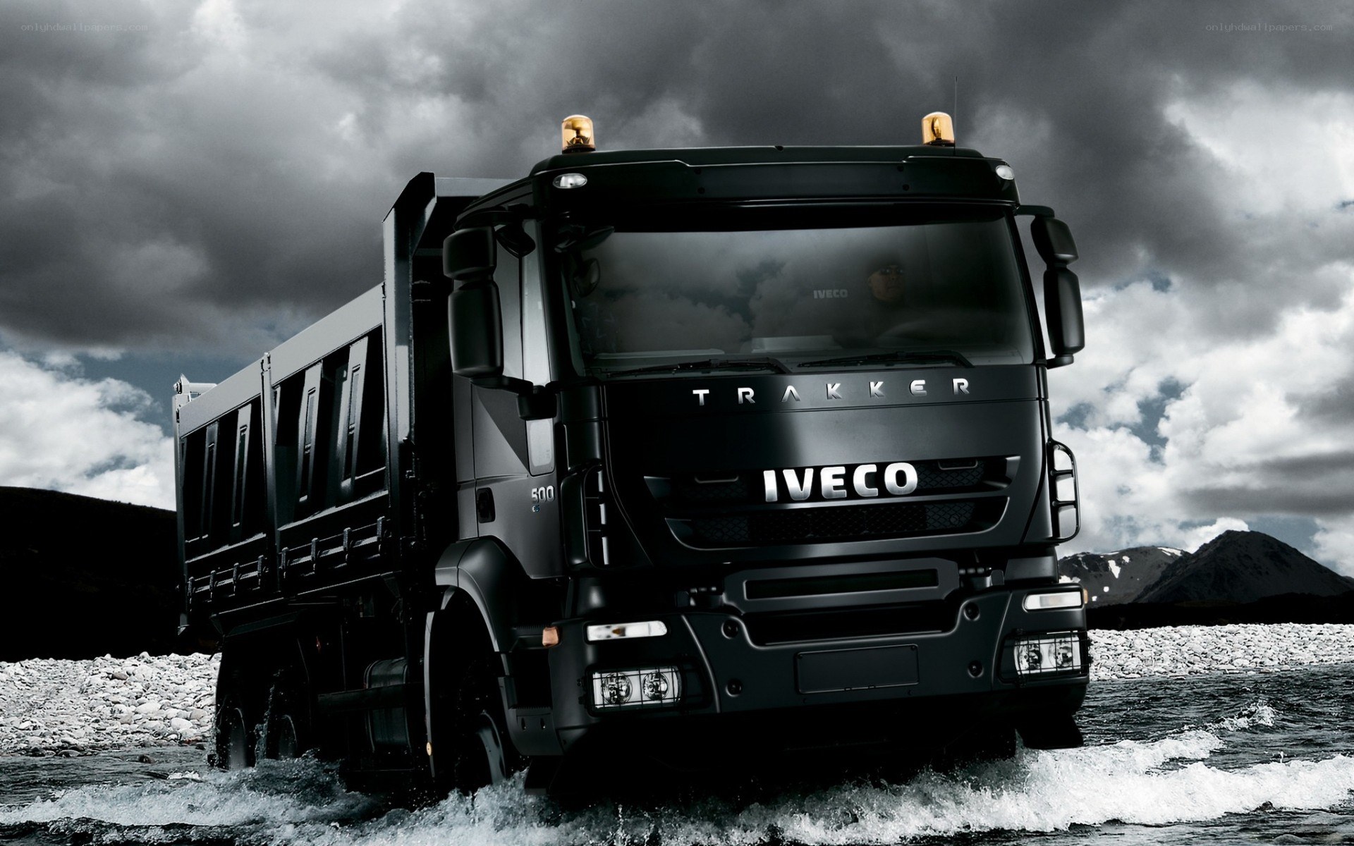 Black Iveco truck in water