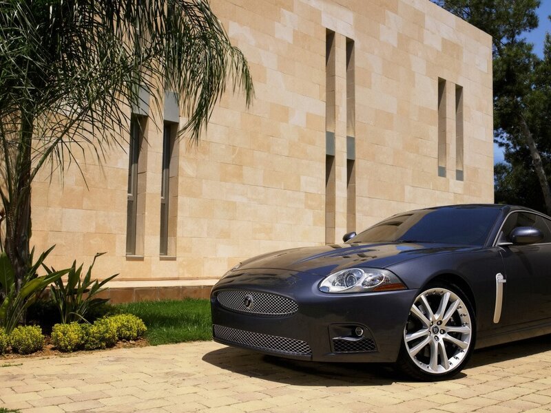 Black Jaguar car in front of building