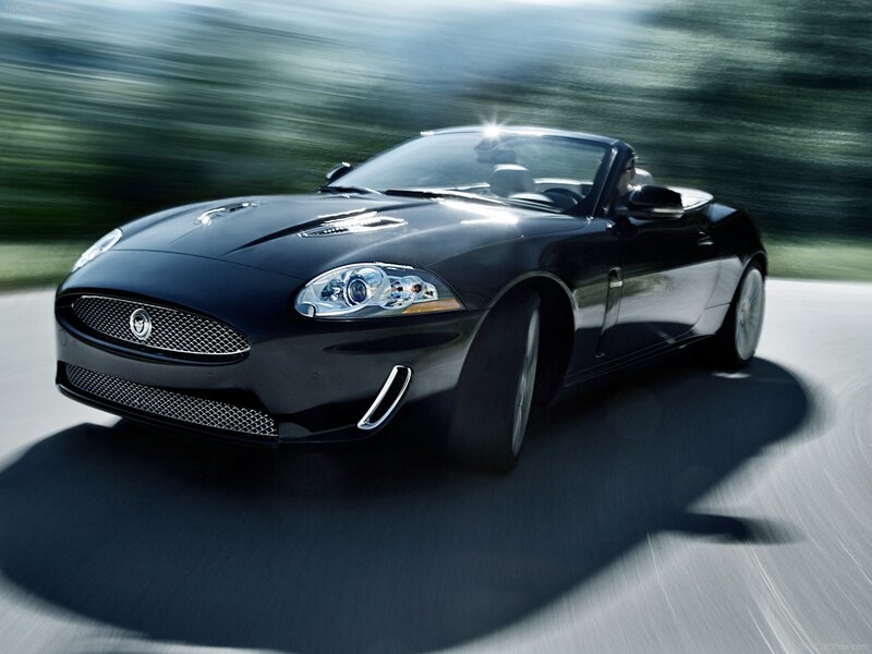 black jaguar convertible in motion
