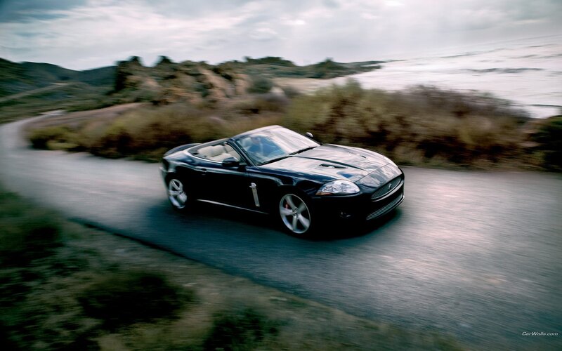 Black Jaguar convertible on coastal road