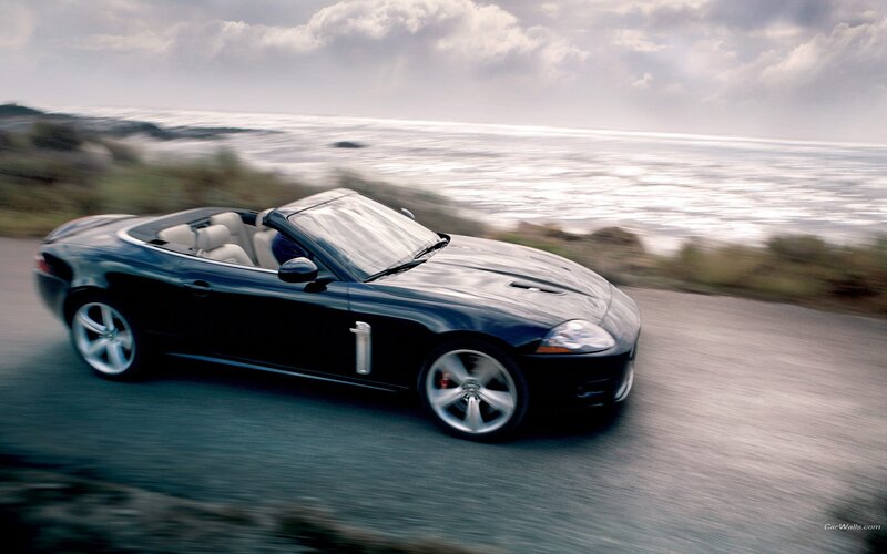 Black Jaguar convertible on coastal road