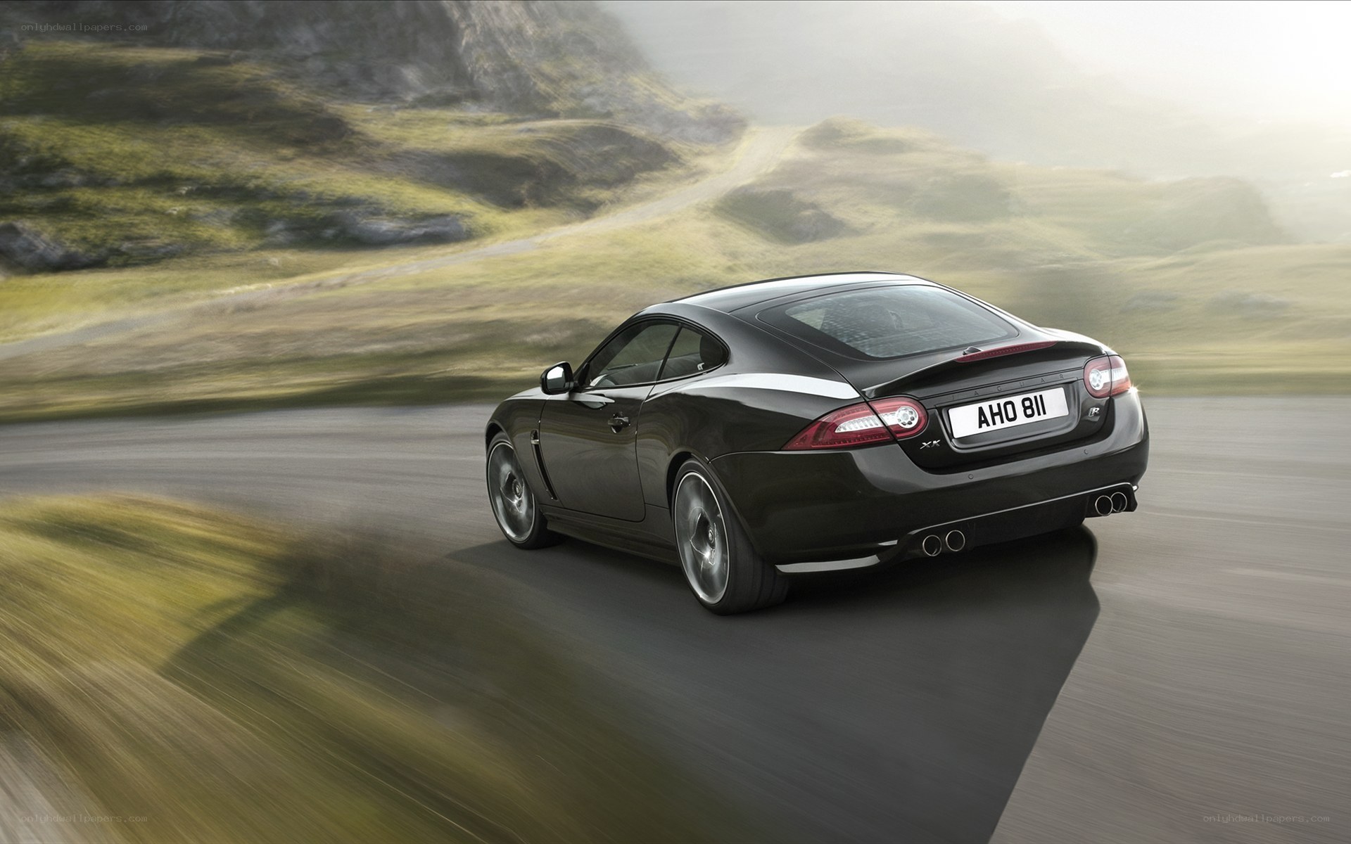 black jaguar coupe on road
