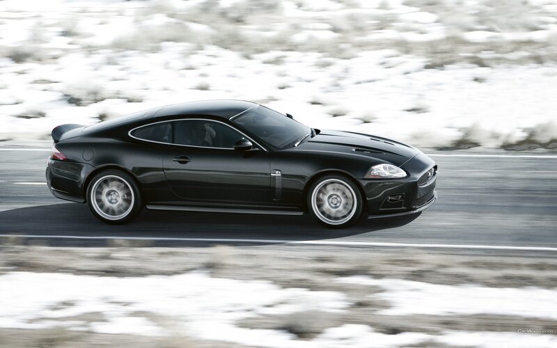 black jaguar coupe on snowy road